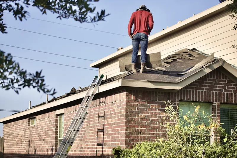 Professional roofer working on a residential roof in Old Great Falls Historic District